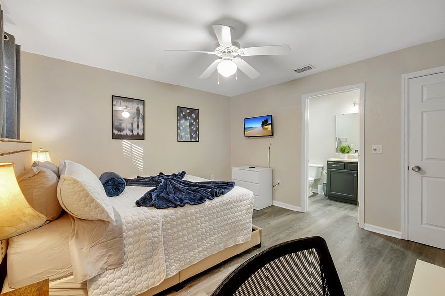 Catch up on your favorite shows from bed with a wall-mounted smart TV.