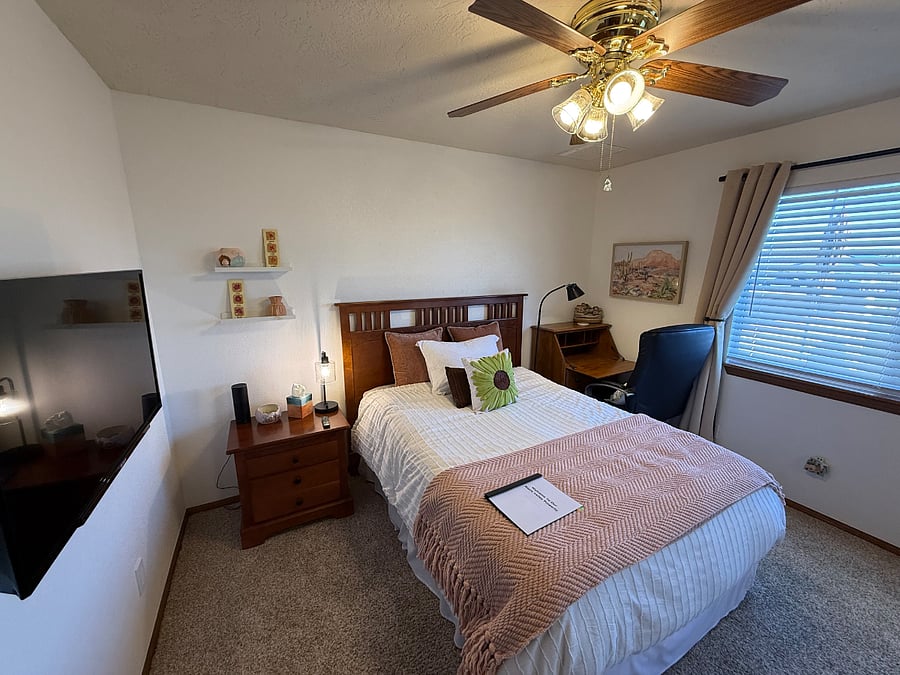 Bedroom 1 with full-sized bed, flat screen smart television, desk