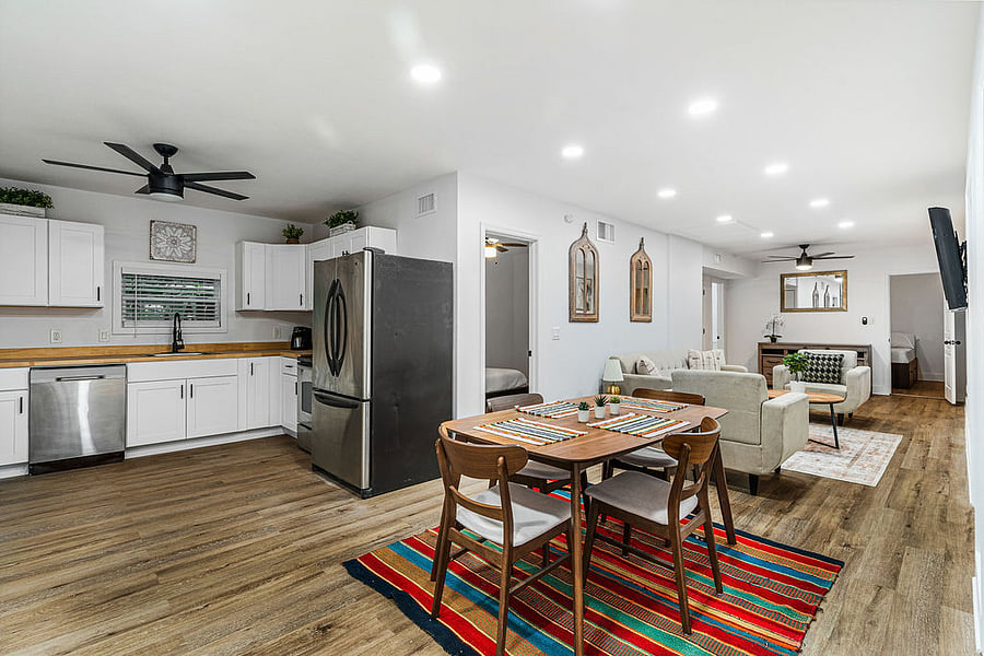 Spacious kitchen and dining area leading to living room.