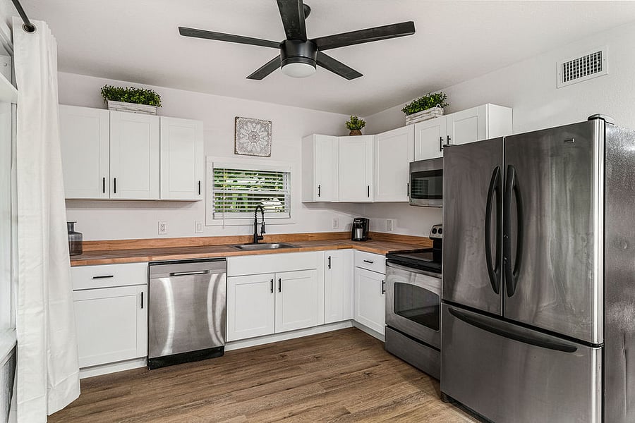 Spacious kitchen with full appliances, french door refrigerator, dishwasher, microwave, coffee maker, blender, silverware, plates and general appliances.