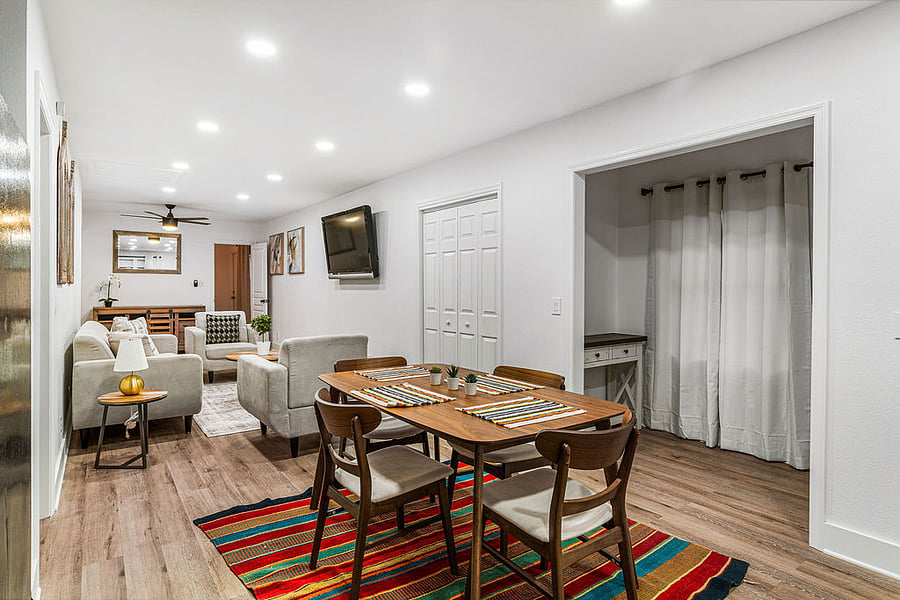 Dining area with cozy sitting nook and living room with sofa and 2 loveseats
