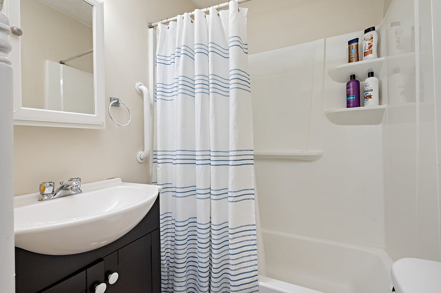 Clean, full bathroom with fresh towels provided.