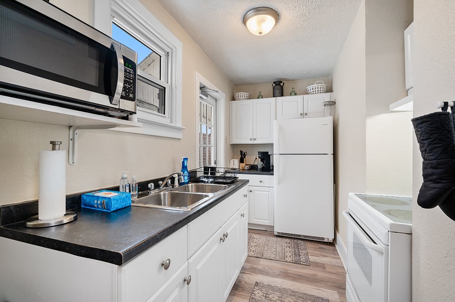 Fully equipped kitchen with cookware, dishes, and essentials.