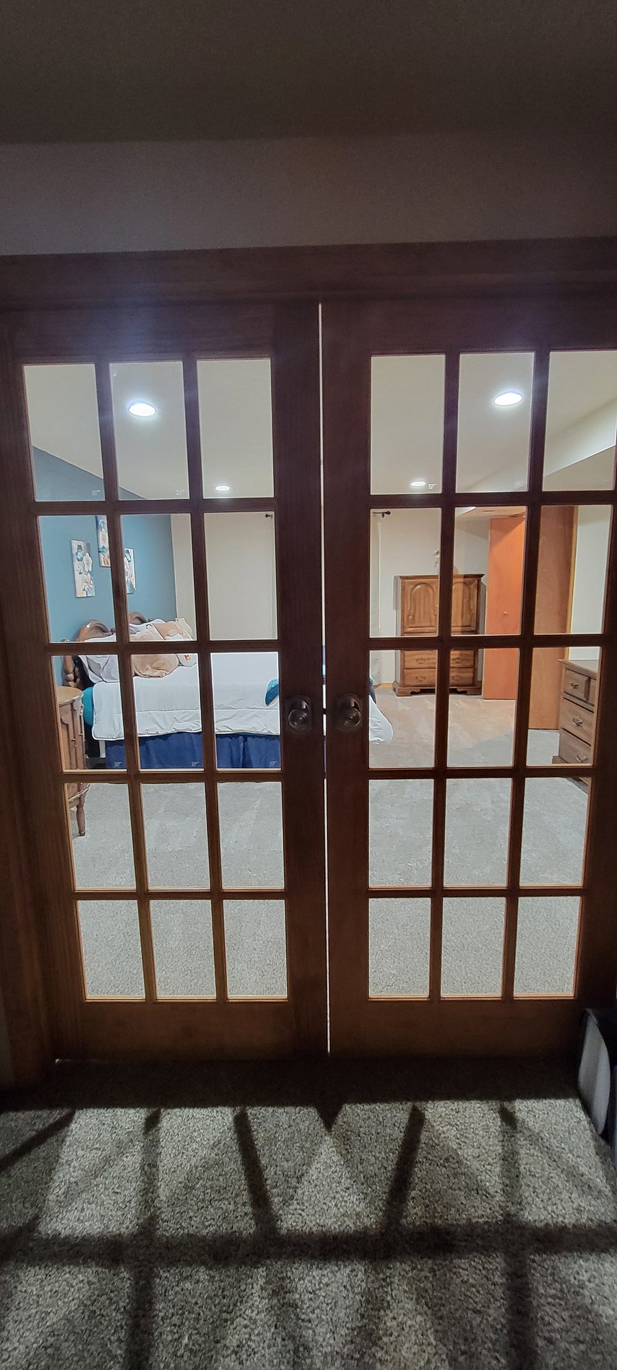 French doors with curtains. Entry to bedroom