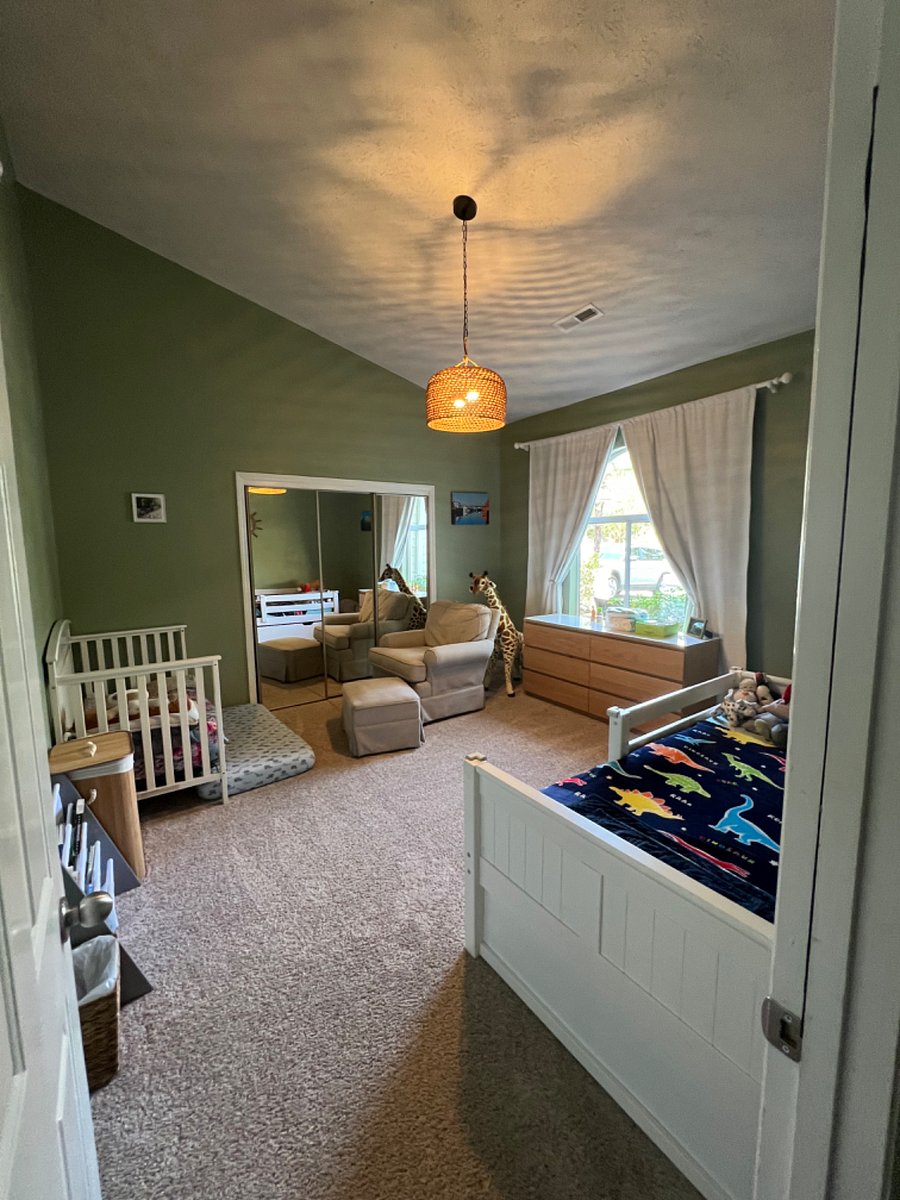 bedroom #2 setup with single bed (trundle bed/mattress underneath) and toddler crib