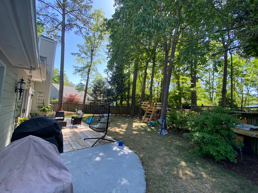 fenced in backyard with tree fort