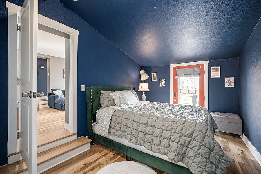 Room comes equipped with bed frame and mattress, bedding, lamp, nightstand, ottoman with storage, and rug.