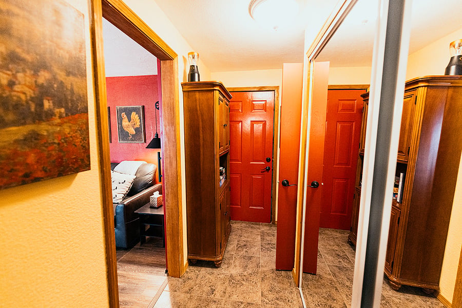 The full-size closet has sliding mirrored doors that can be seen on the right-hand side of this picture of the hallway that separates the sink & toilet room from the shower room.