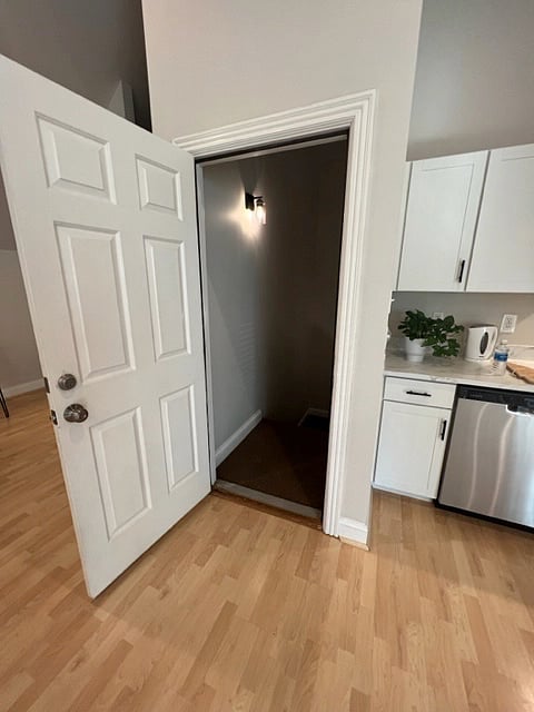 Stairs to the lower level off kitchen