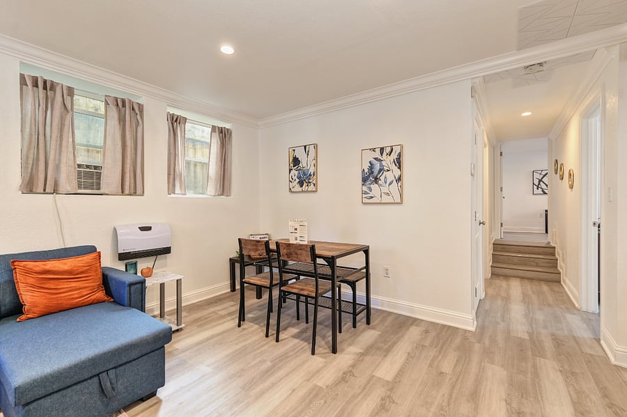 The stylish dining table for four is perfect for intimate meals, productive workdays, or relaxed conversations. Whether enjoying a homemade dinner or brainstorming over coffee, this inviting space adds a touch of warmth and connection to every stay.