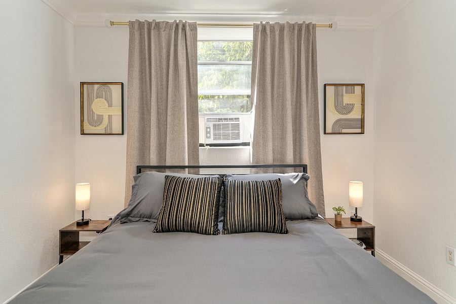Enjoy this chic bedroom with a memory foam hybrid bed, nightstands, and soft lighting on each side. Unwind with your favorite shows on the TV in this cozy, tranquil space. Its designed to feel like home, offering warmth, relaxation and peace for you