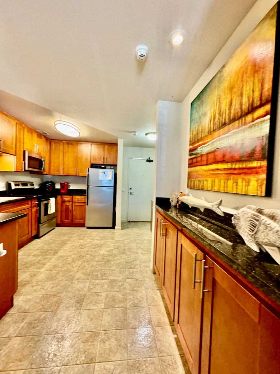 Full-size kitchen with 2 bar stools to eat at the counter.
