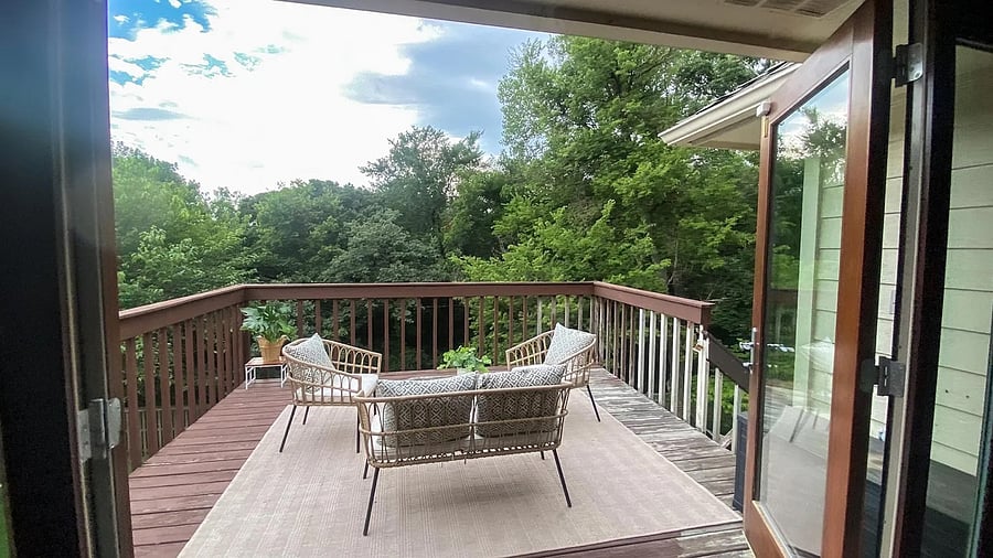 French doors off of second living room giving you access to the upper deck and patio furniture.