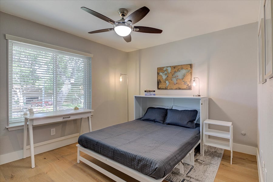 Third bedroom can be flexible. It has a queen size murphy bed, end tables when bed is in use. There is also a desk and chair and rowing machine.
