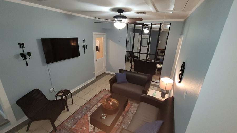 Opposite angle of living space. Full wall mirrors . 