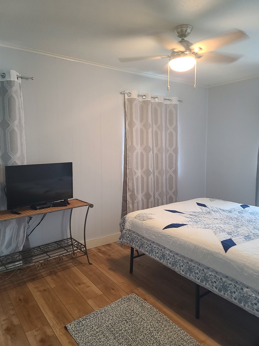 Entering the bedroom. Queen memory foam bed with Amazon Fire TV (also runs Dish satellite for live TV). 