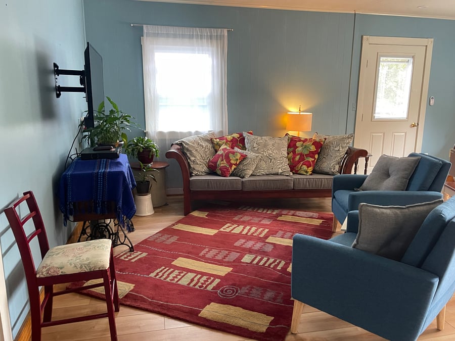 Living room with comfy couch, smart TV and relaxed vibe.