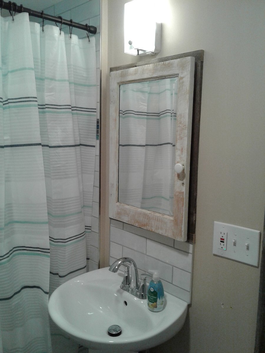 Bathroom with pedestal sink. Custom built medicine cabinet with a vintage flair.
