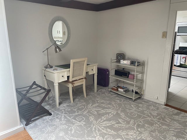 Also in the living room, a desk for remote working and book shelves for storage.