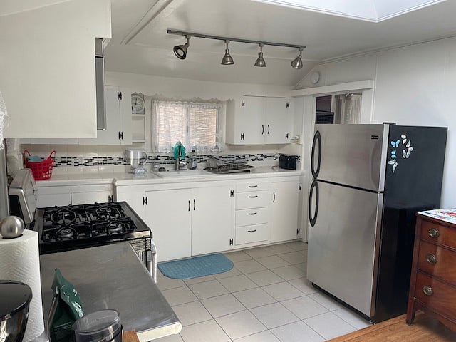 Stainless steel appliances and food preparation area.