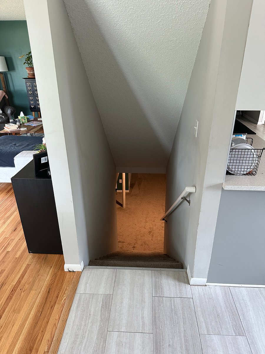 Stairs are next to the main door lead to lower level