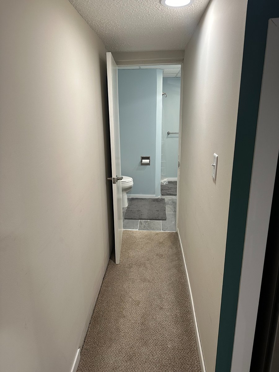 Hallway to bathroom, full-length mirror behind the door