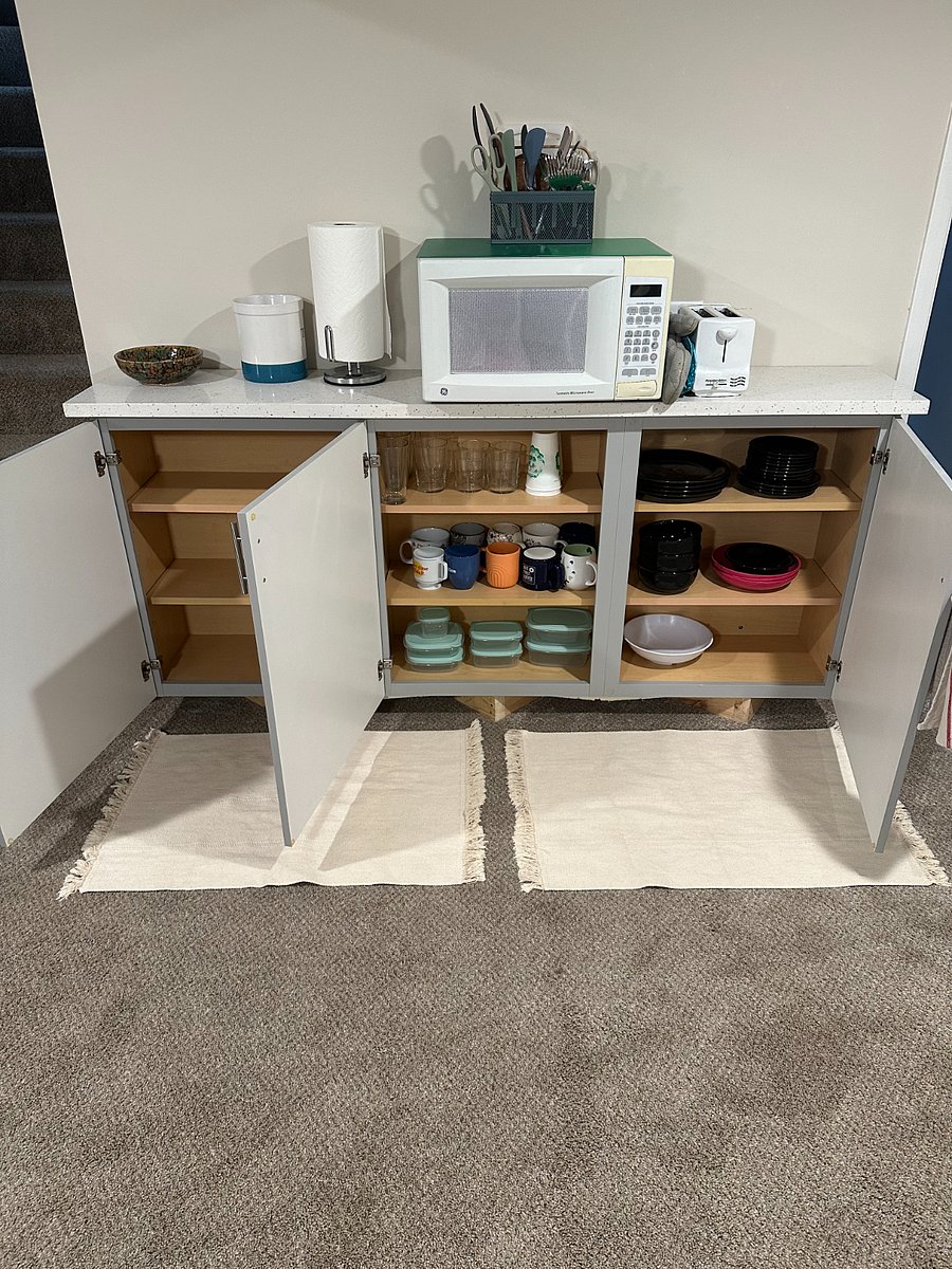 Dishes provided, including plates and bowls of varying sizes, glasses, mugs, and plastic storage containers. Bring your dishes upstairs after use to be washed in the dishwasher, easy!