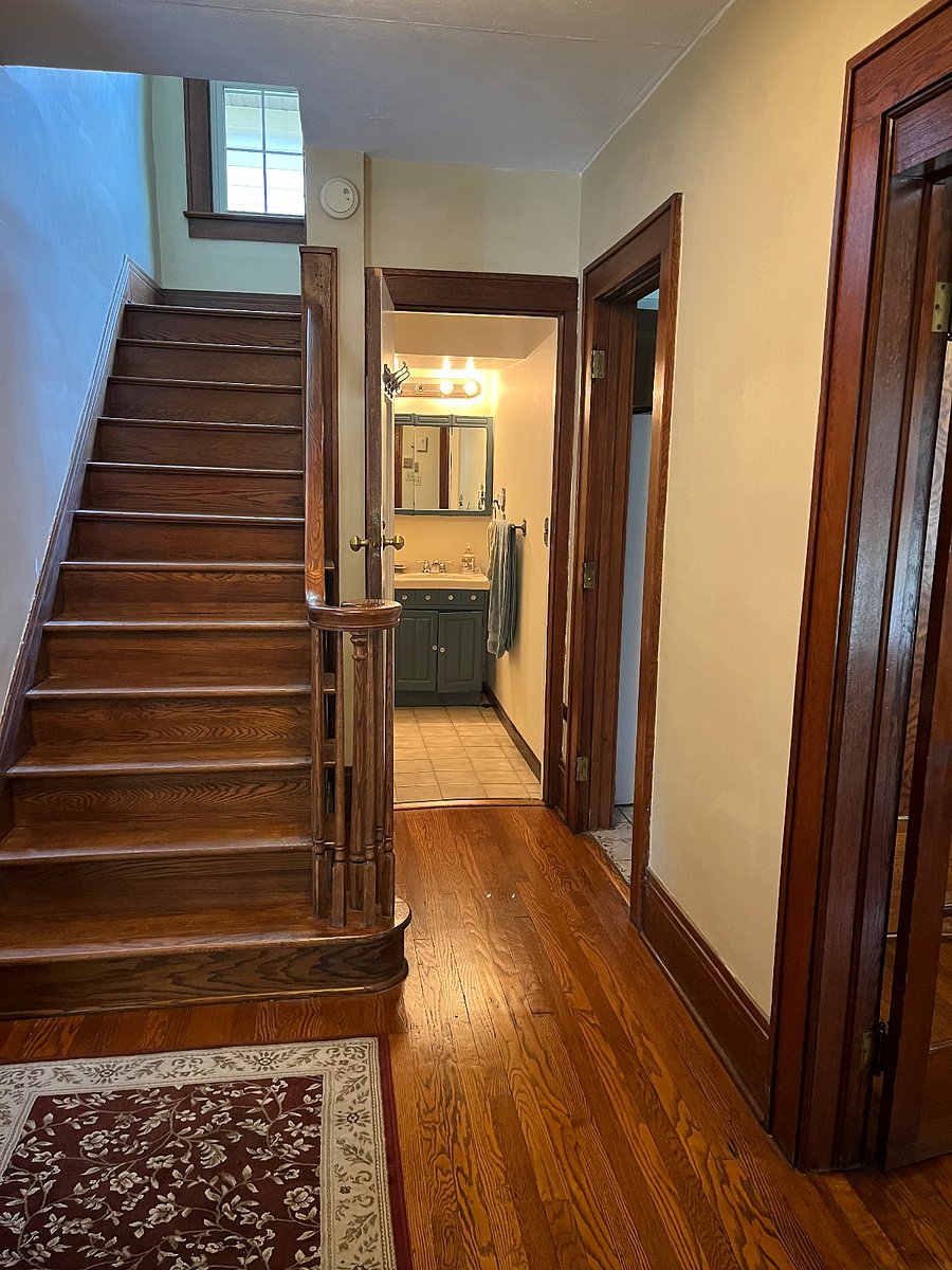 Hallway, connecting bathroom kitchen bedroom living room. Stairs go to extra closet.