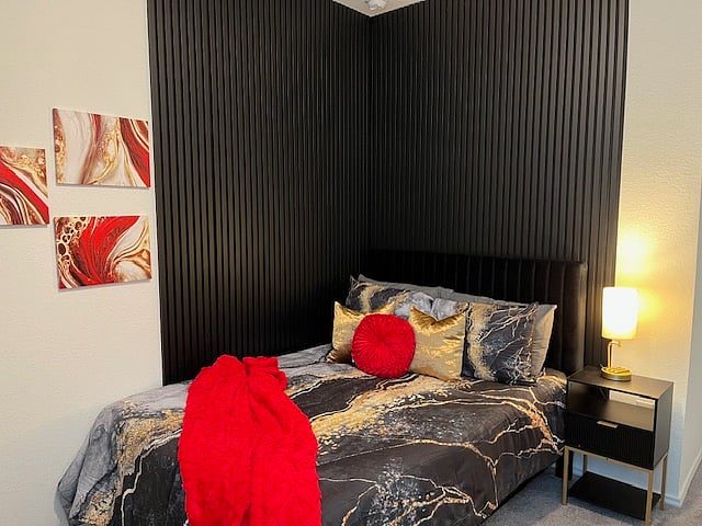 Guestroom 2 "The Red Room" features a full bed with nightstand, long dresser, and walk-in closet