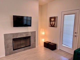 gorgous wood-burning fireplace, with Smart TV, across from living room