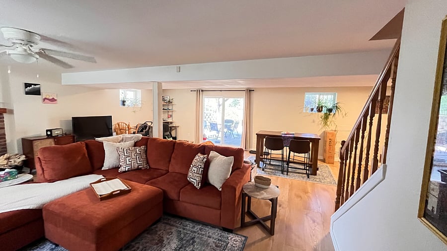 Walkout basement with table, comfy couch and a smart tv!