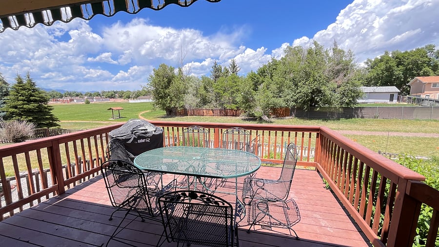 Patio off of kitchen, with a propane grill and a table that seats 6
