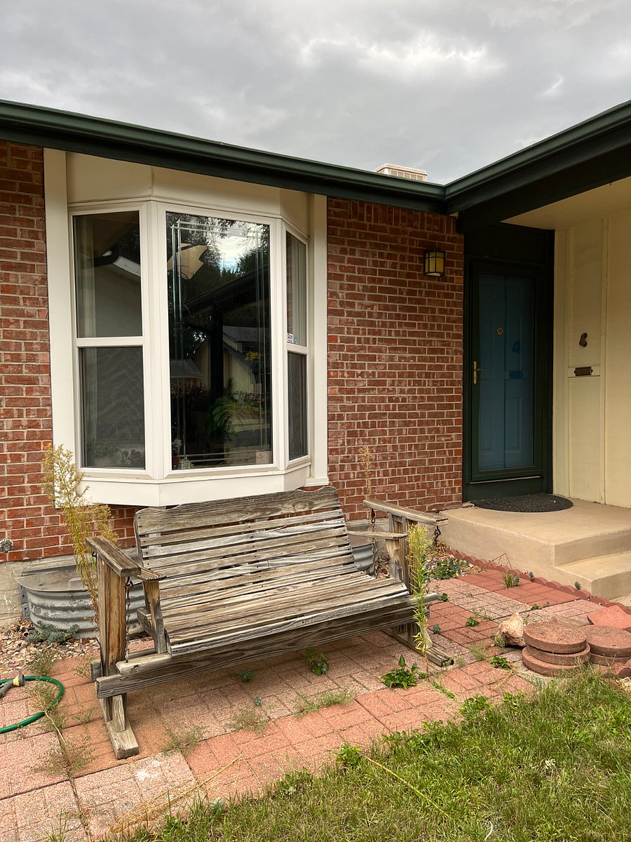 View of front door and bay window, lots of sunlight on this side of the house