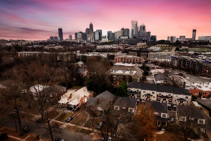 Enjoy the best of city living with a tranquil neighborhood vibe! This aerial view showcases Kings Quarters' prime location, nestled in a charming area with stunning city skyline views. Perfectly situated near local attractions while offering a peaceful retreat