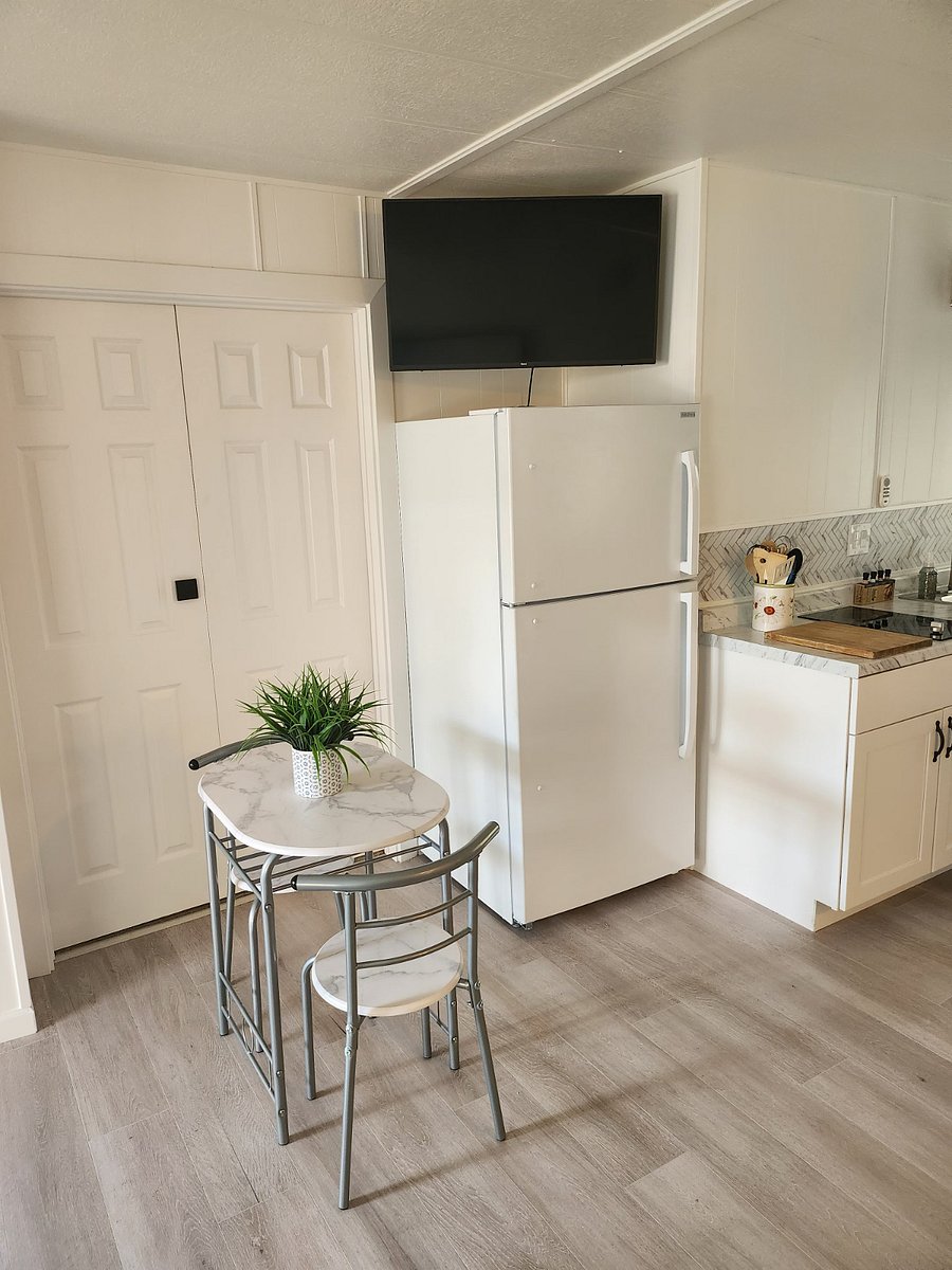 Full size refirg and small dining table for 2 people. That is a 42 inch new Smart TV