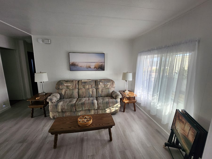 Living room with couch that extends back on both ends