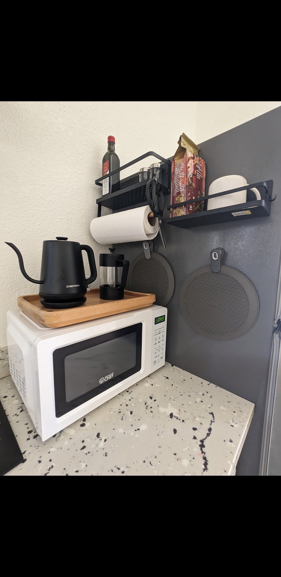 Mini coffee/tea bar features a sleek electric kettle & french press with handy spice racks for all your delicious favorites.