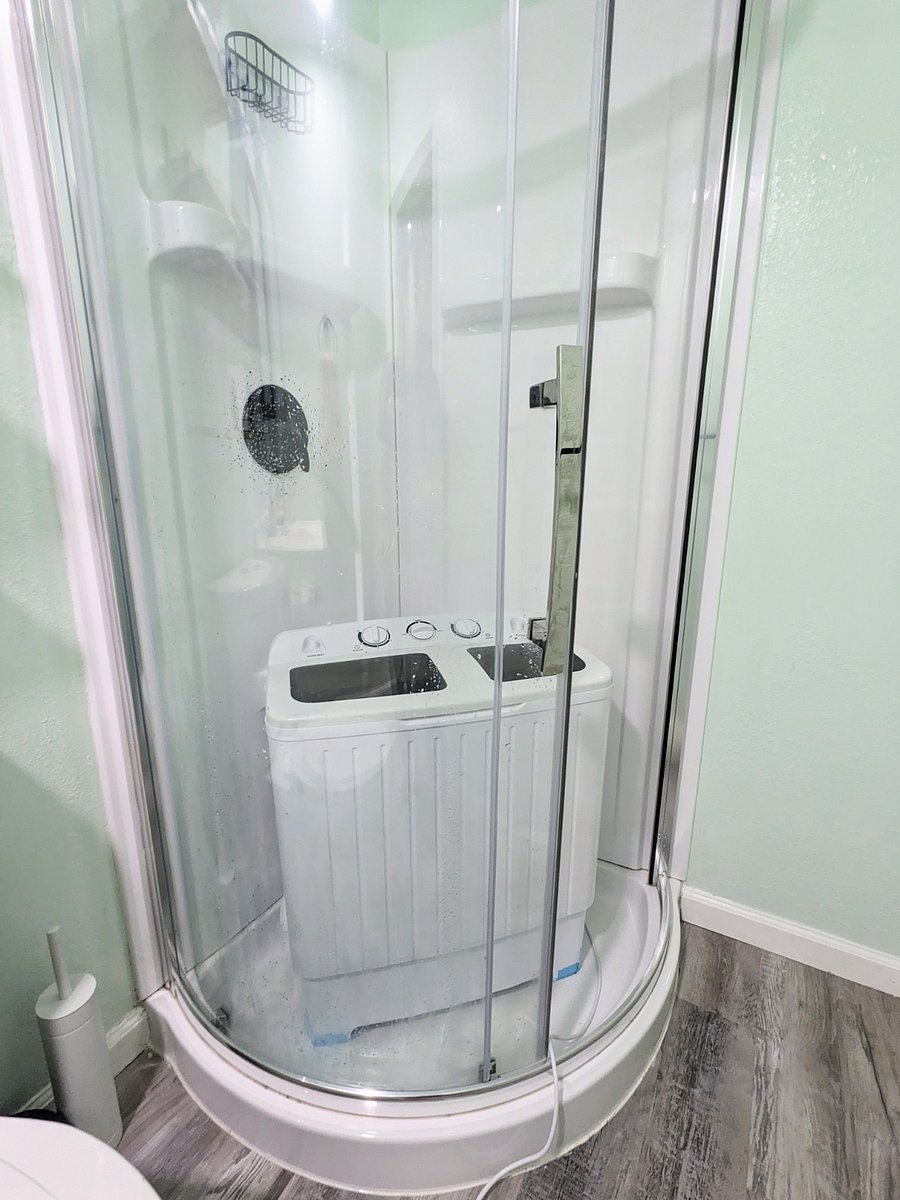 Mini washer & spin dryer can be used with the shower head & drain to wash your essentials between laundromat visits. Folding drying rack is tucked behind the bed for your convenience.