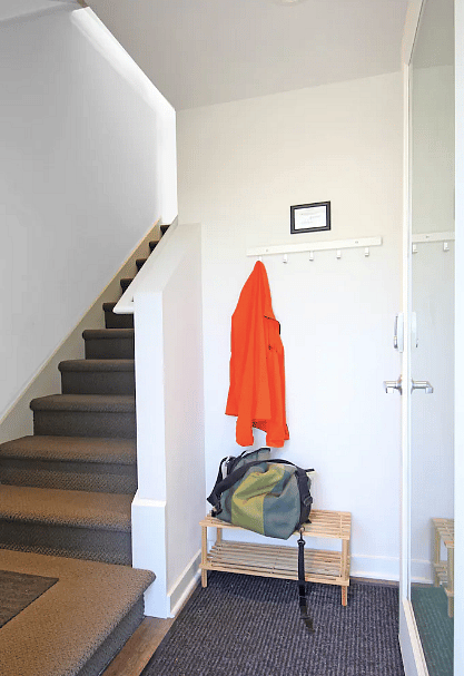 Entry standing at front door. Laundry closet is to the right.