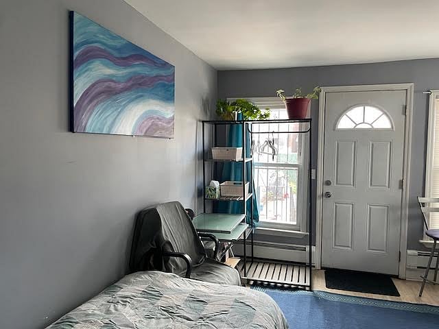 Clothing storage with hanging closet rack. Plenty of natural light with room darkening blinds.