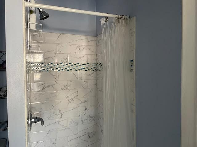 Stand up shower with subway tile design with toiletries provided.