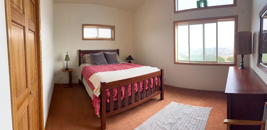 Second bedroom with queen bed with bay and bridge view