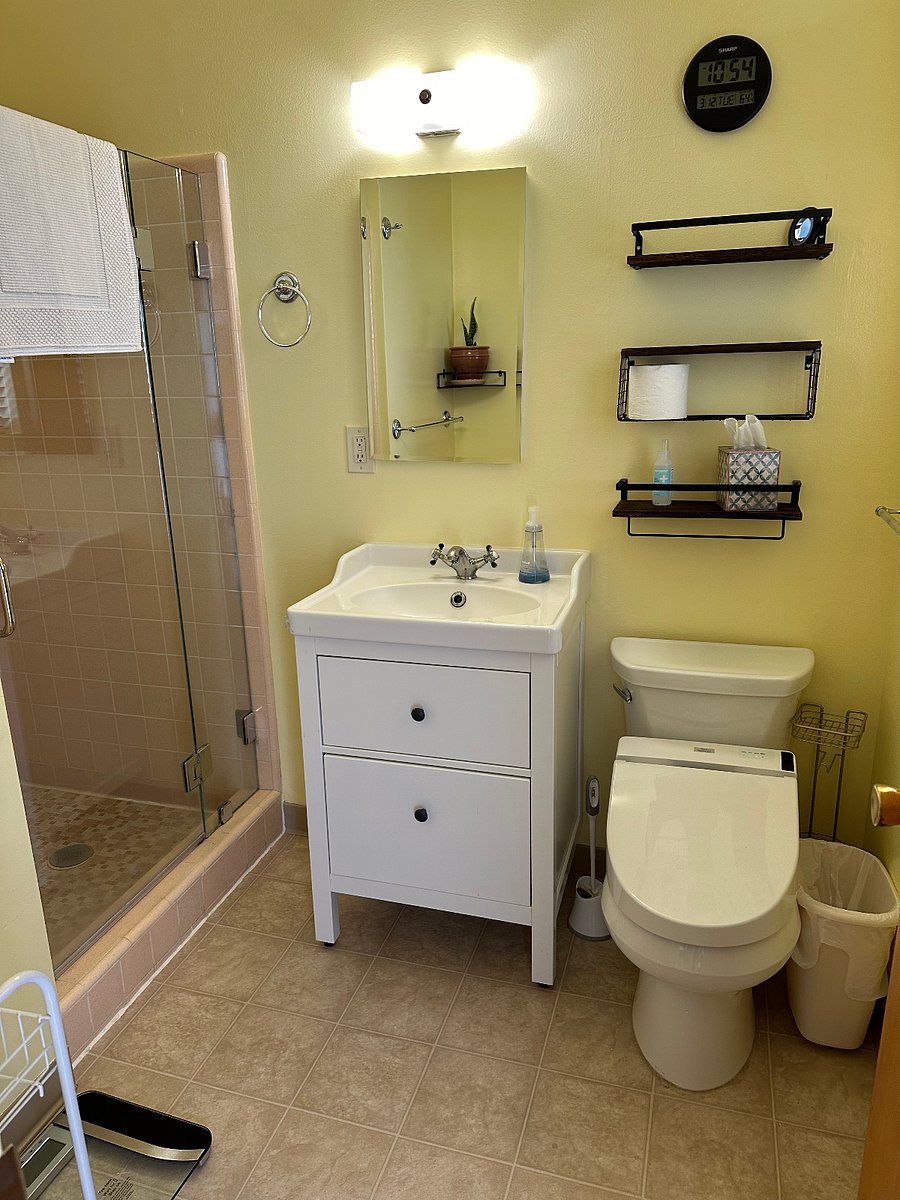 Master bedroom private bathroom shower with Toto bidet washlet and ventilation fan.