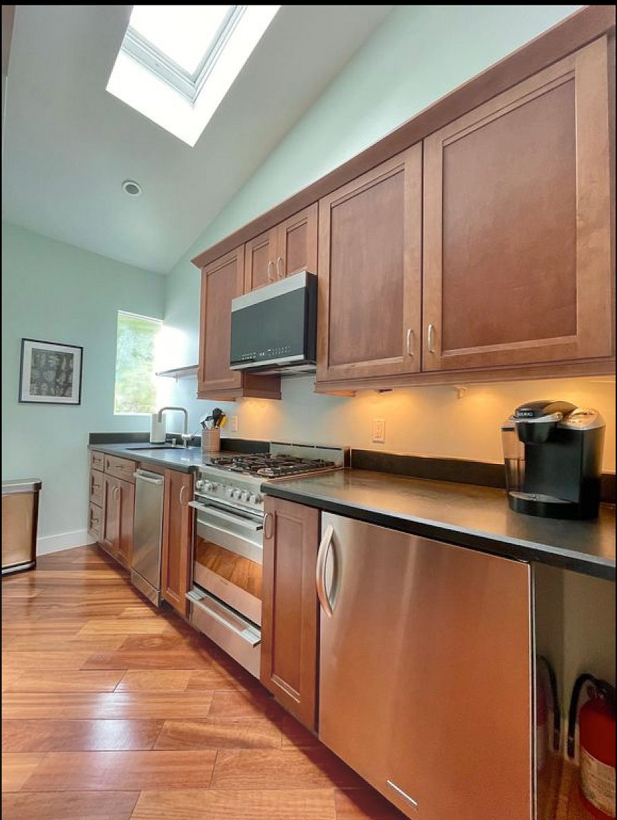 Granite countertops, Bosch dishwasher, Fisher-Paykel oven range, Grohe fixtures, sink disposer, microwave vent hood,  separate food/beverage refrigerators.