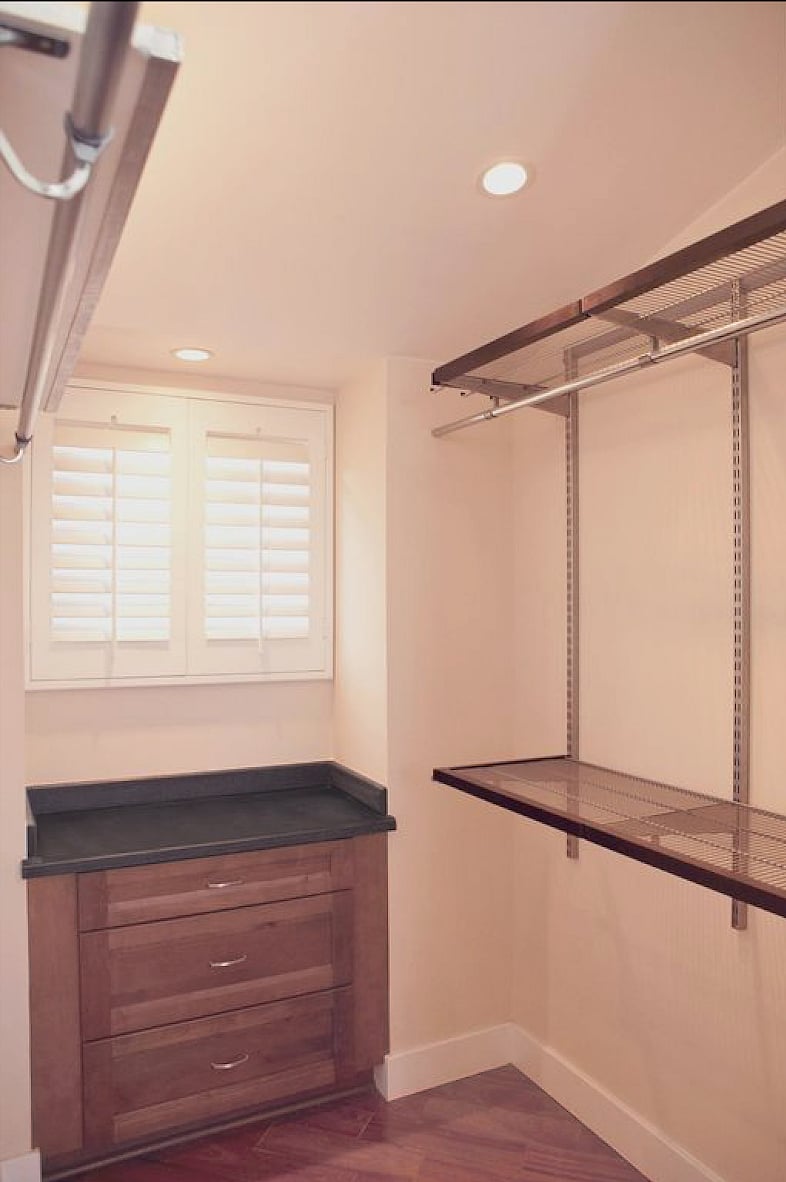 Walk in closet with built in drawer stack.