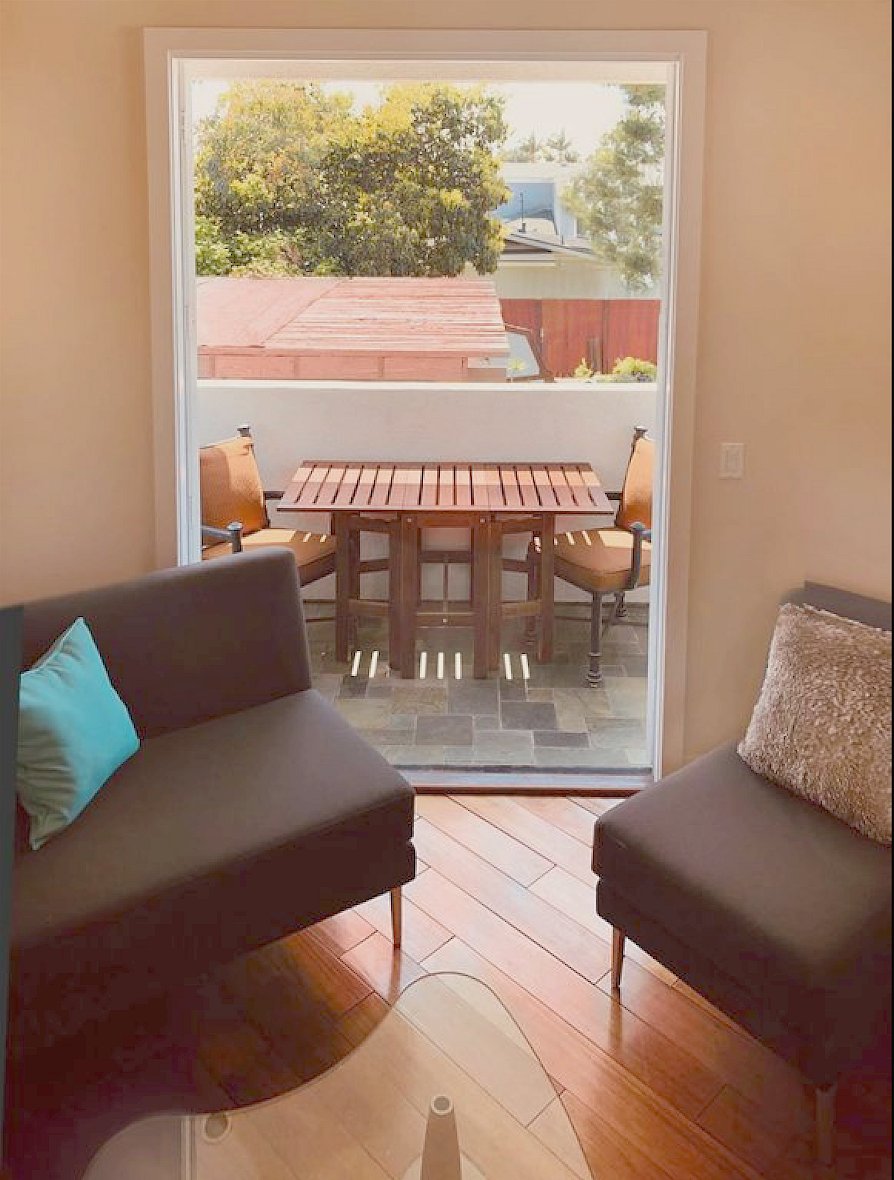 Private balcony with table and chairs.