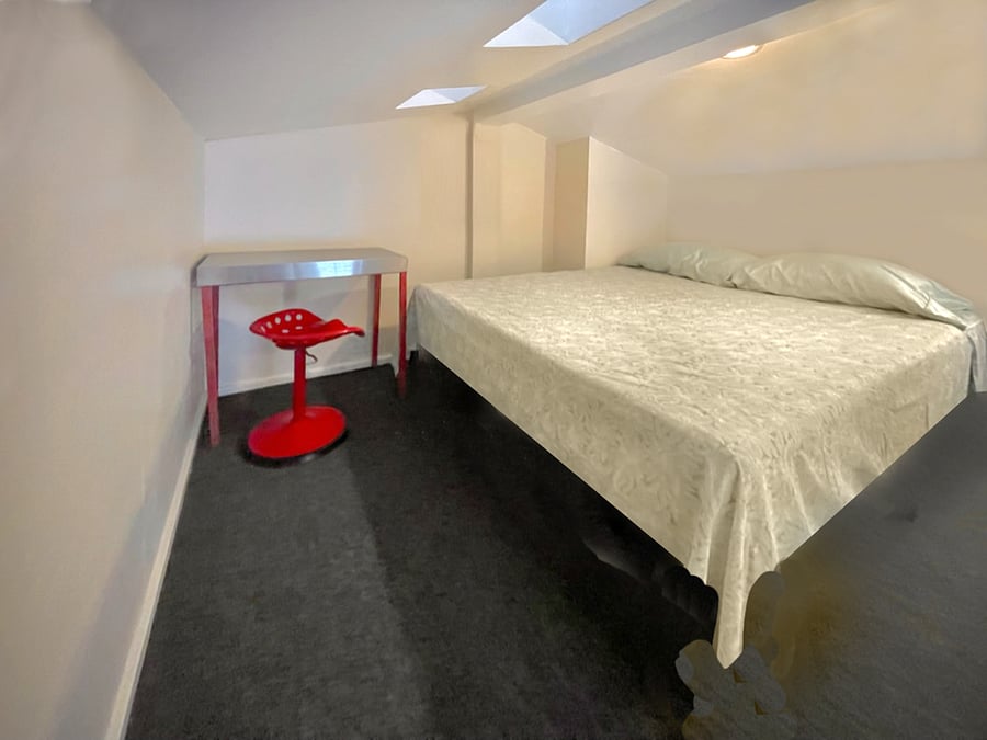8 ft x 10 ft sleeping loft with queen size bed.