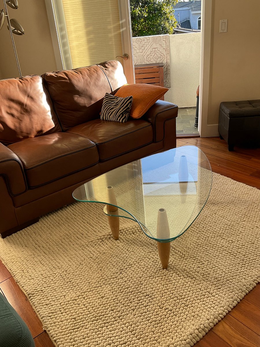 Mid century glass coffee table. New leather sofa.