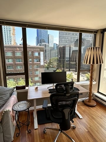 Adjustable standing/sitting work desk with lovely city views.