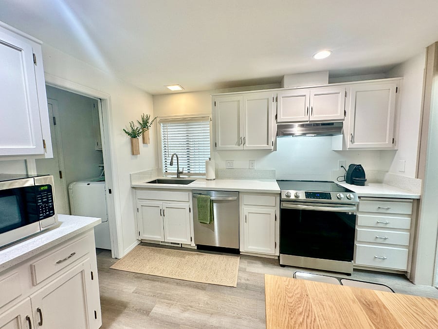 Fully equipped kitchen with all you need to get cooking! Brand-new stainless-steel appliances and a handy kitchen island with stools.